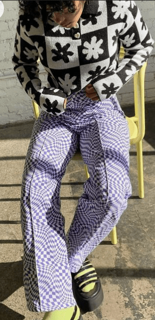 A woman wearing cream and purple pattern pants
