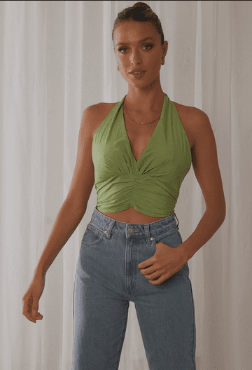 A woman wearing a green halter top