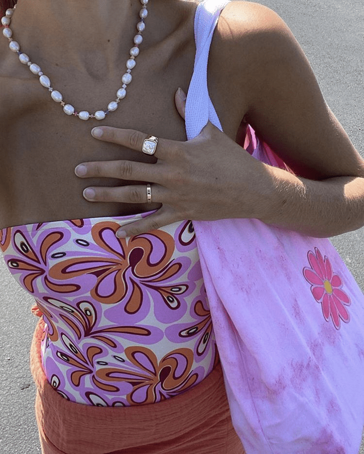 A woman wearing a colorful pink print top