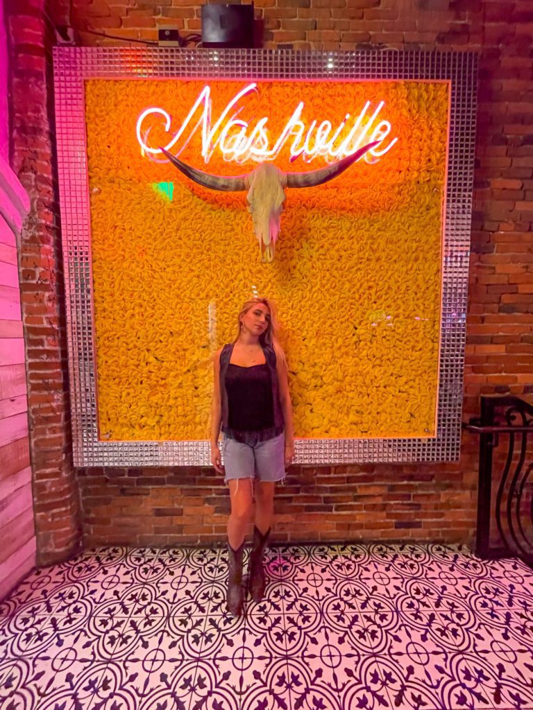 Levy Silverstein in front of a Nashville sign