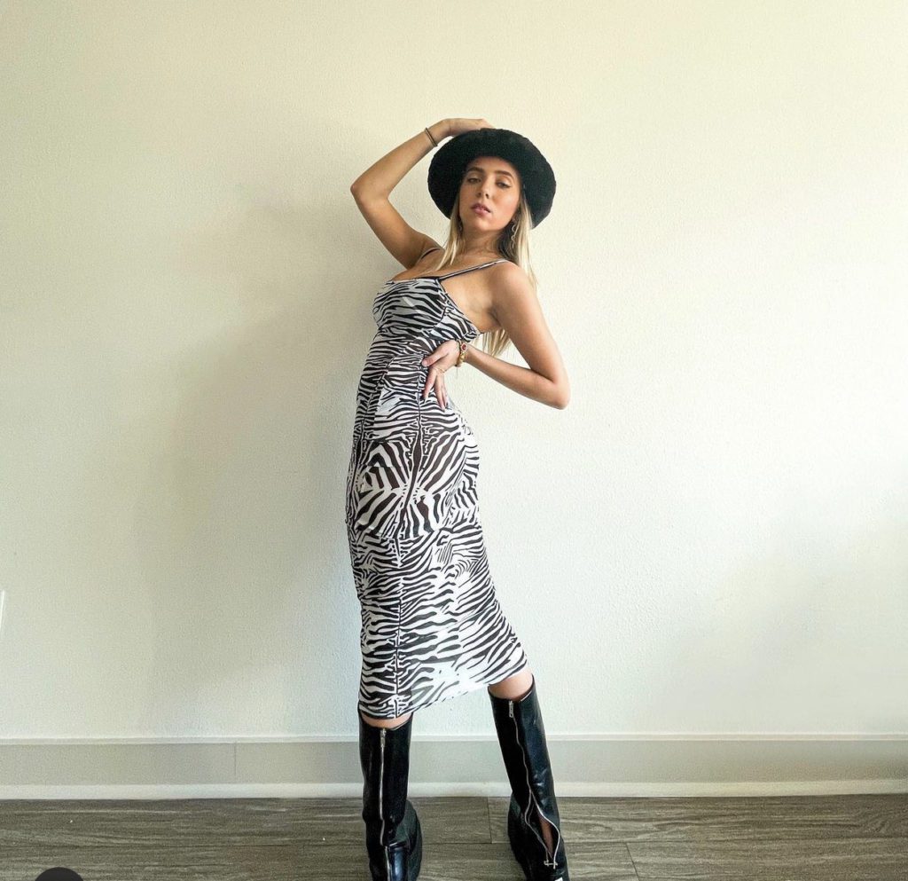 Lexy Silverstein in Thrifted Black Boots and a Zebra Dress Rented at Nuuly 