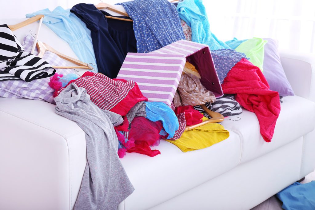 Messy colorful clothing on a sofa